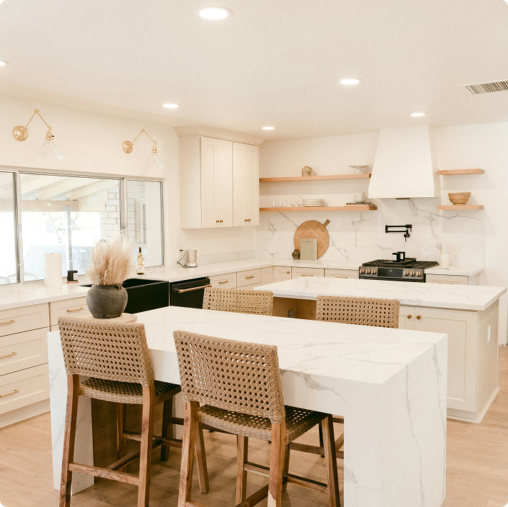 Modern kitchen interior featuring light cabinetry, marble countertops, and woven bar stools, emphasizing quality and detail in home design.