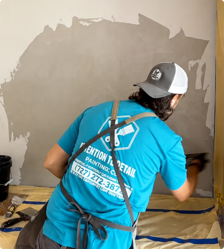 Attention to Detail crew member troweling plaster onto an interior wall