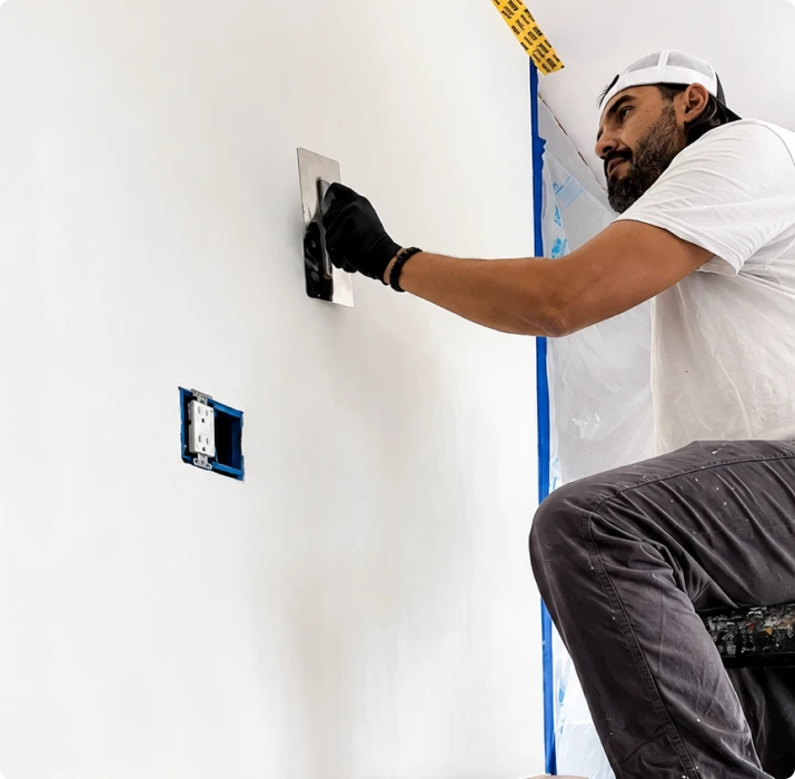 Attention to Detail painter troweling a lime finish onto an interior wall